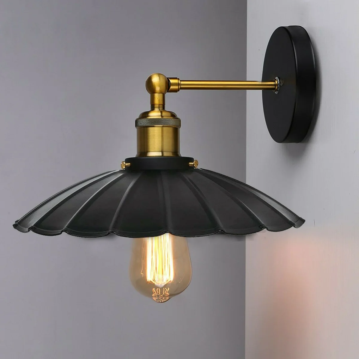 Black wall lights with matte black metal finish and minimalist shade mounted on a white wall in modern interior setting