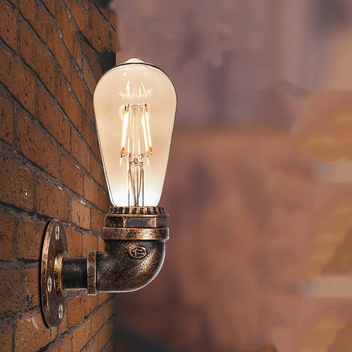 Rust-colored vintage industrial steampunk wall sconce made from metal water pipes with E27 bulb included, mounted on wall