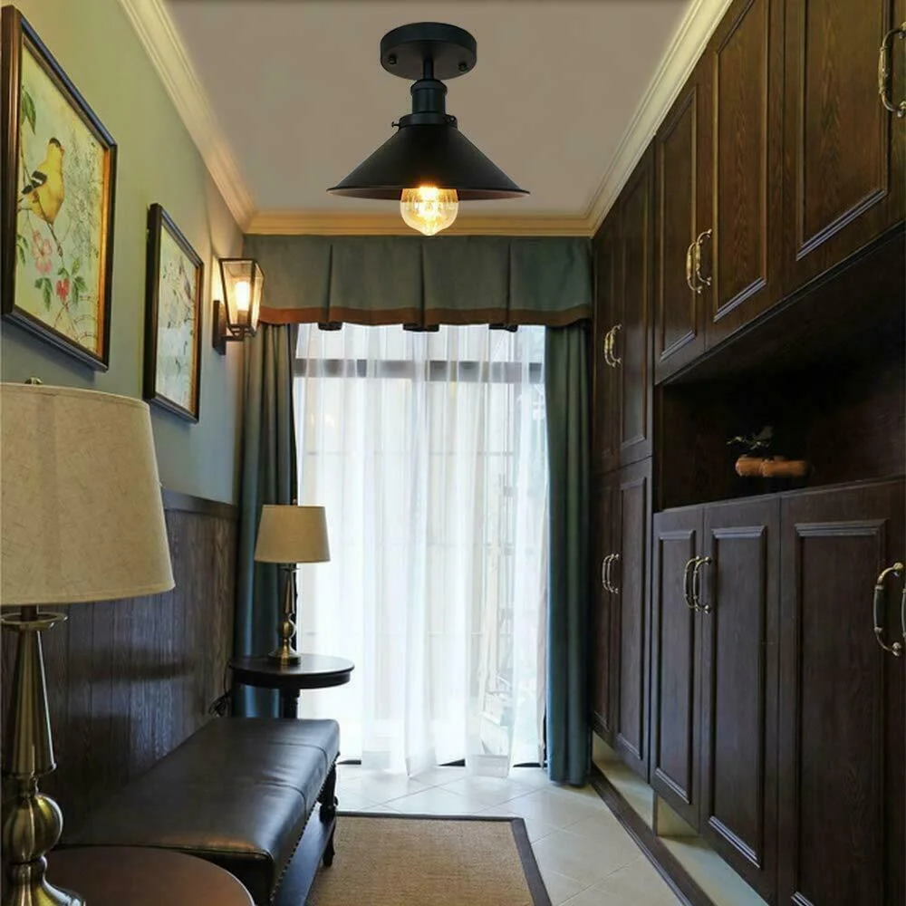 Black and gold metal E27 base ceiling lamp with flush mount shade and decorative brass finish against white background