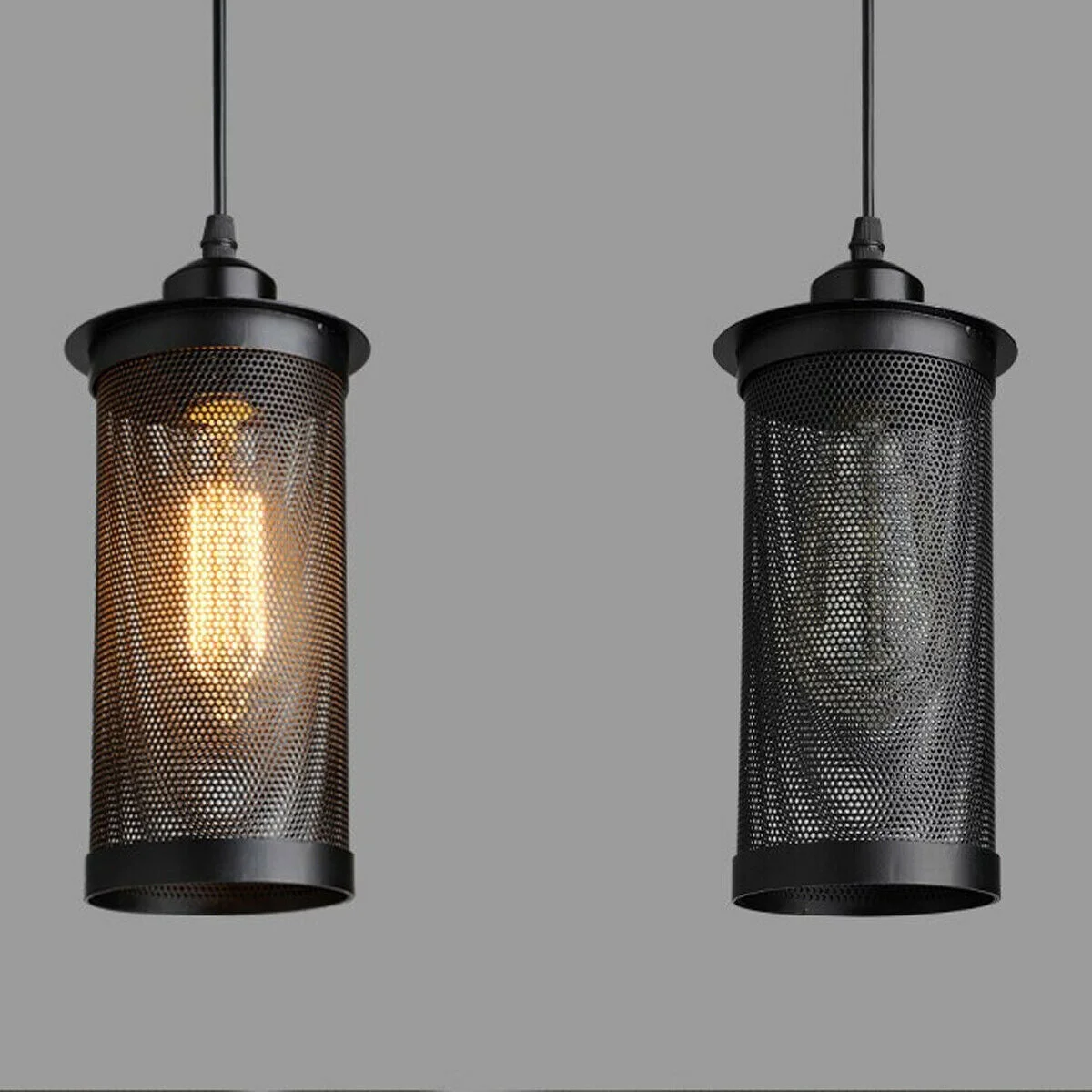 Cluster of three black perforated metal industrial pendant light shades with E27 holders and 90cm cables hanging indoors