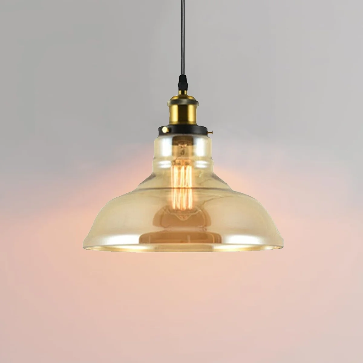Amber glass pendant shade, bowl shape hanging from ceiling, shallow oval top, yellowish tint.