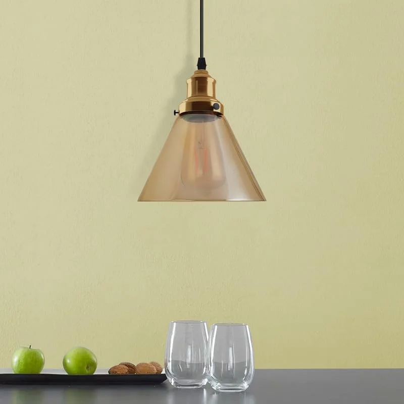 Vintage amber glass retro pendant lampshade with bowl shape and E27 fitting, glowing warmly indoors