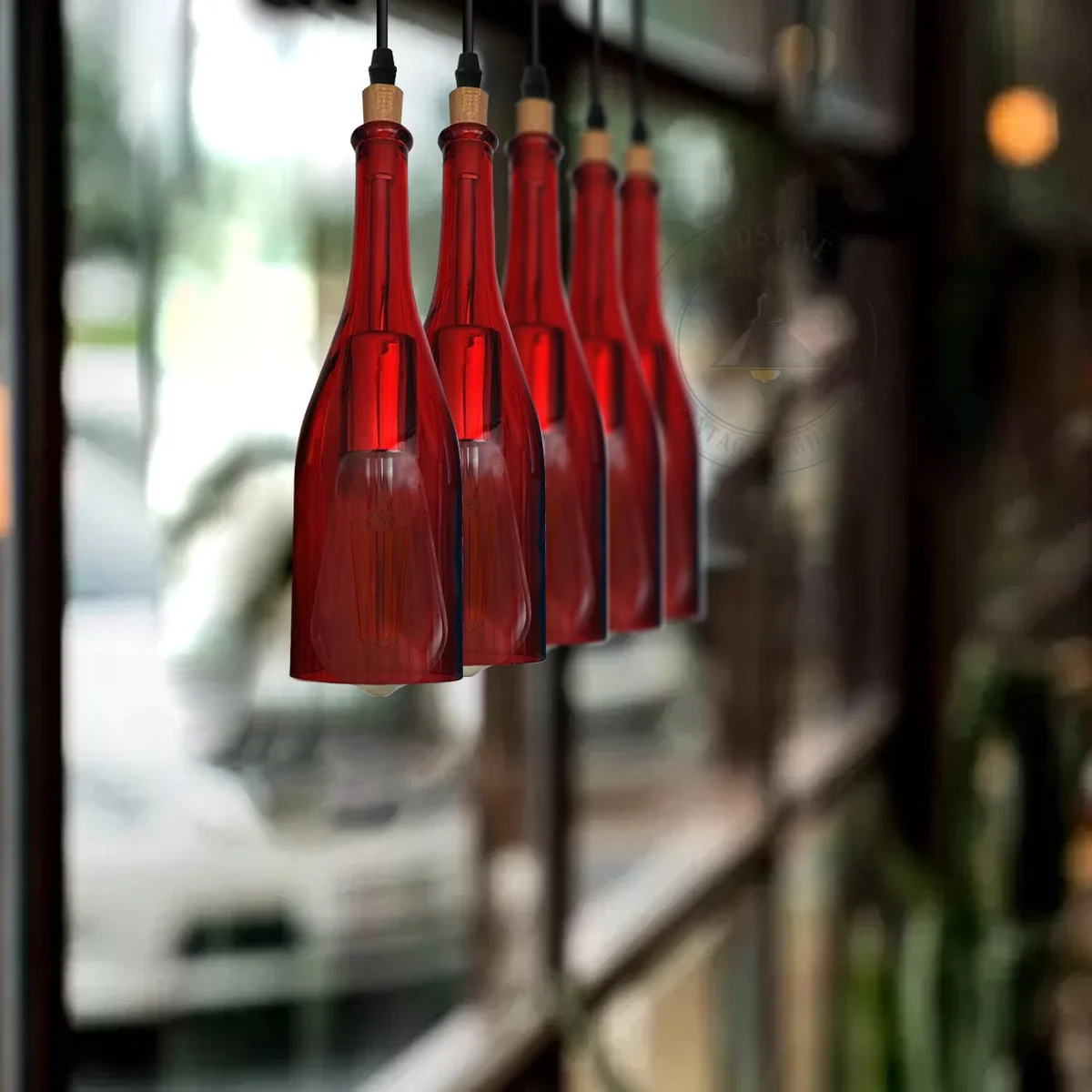 Five-head cluster pendant light with vintage glass shades shaped like wine bottles in blue color hanging from ceiling