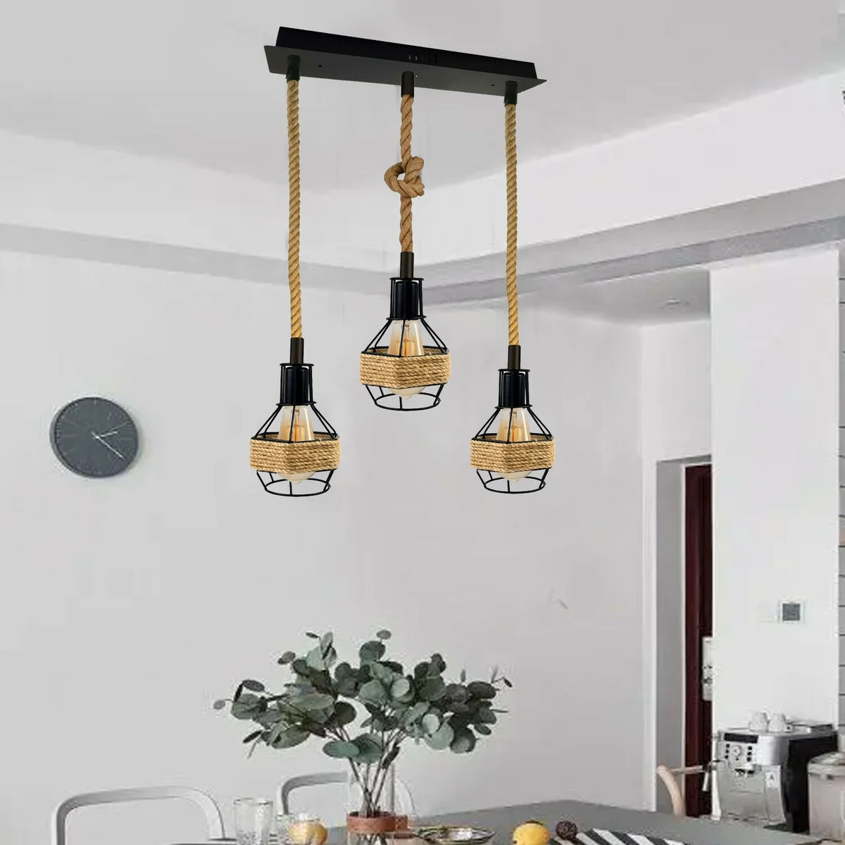 Vintage rope pendant light with three black metal cages and hemp rope cords hanging from a round ceiling plate