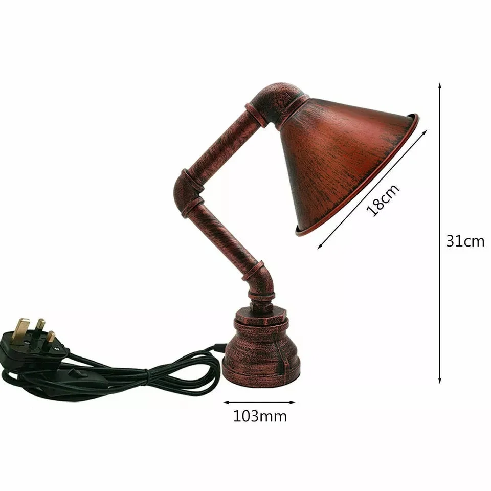 Retro steampunk water pipe table lamp with black metal cone lampshade and inline on/off switch on wooden surface