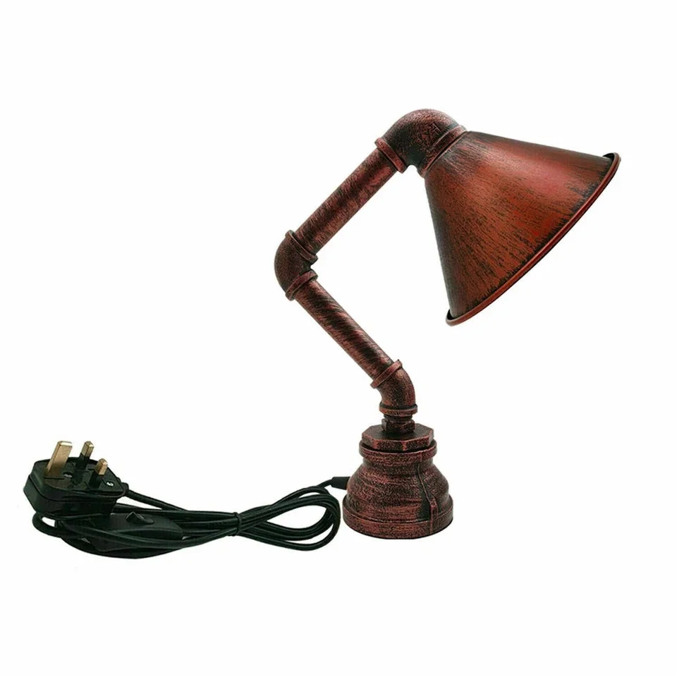 Steampunk table lamp with vintage water pipe design, metal cone shade, black finish, and plug-in switch on wooden surface