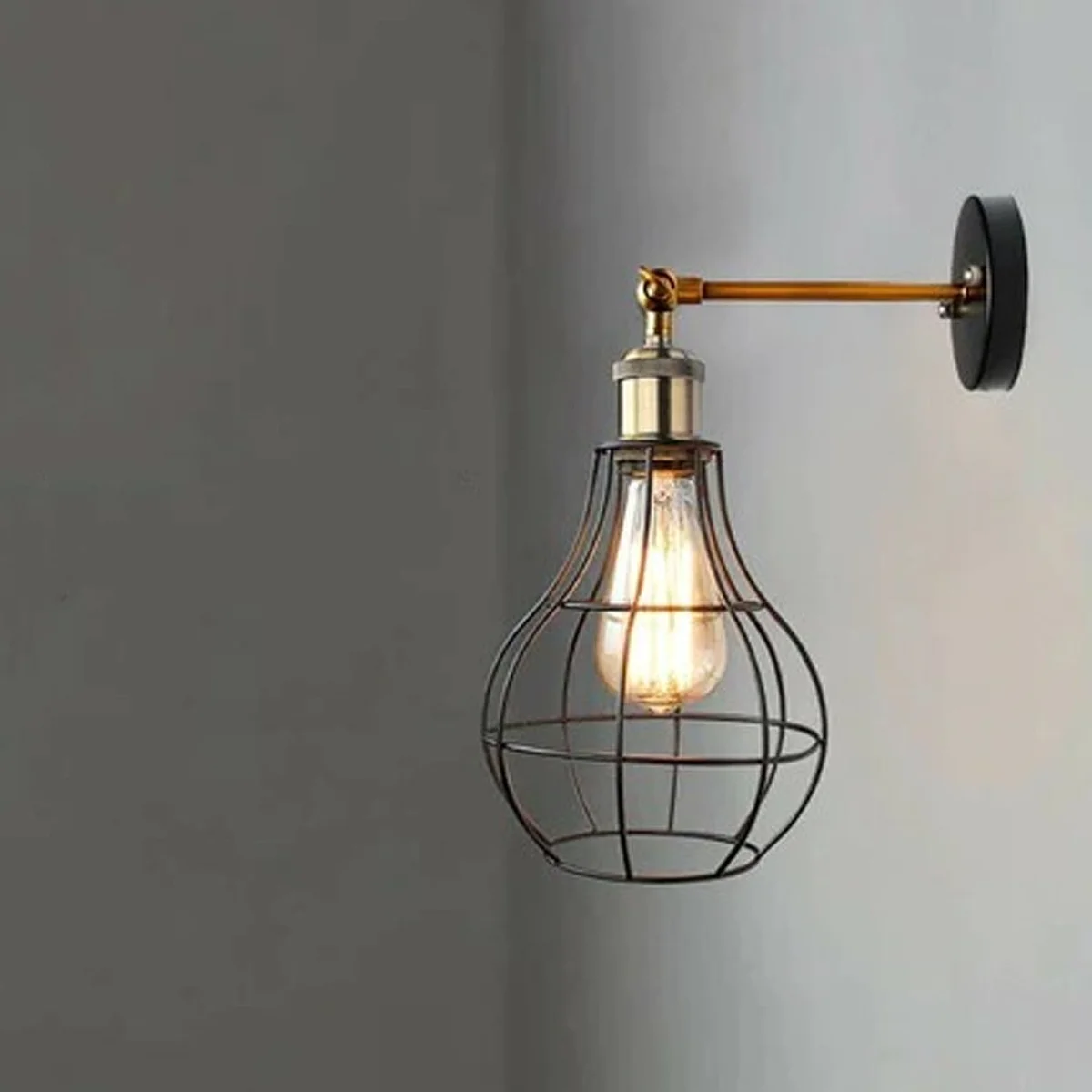 Modern metal E27 wall light with vintage bulb, decorative cage, and ceiling rose for stylish UK interiors.