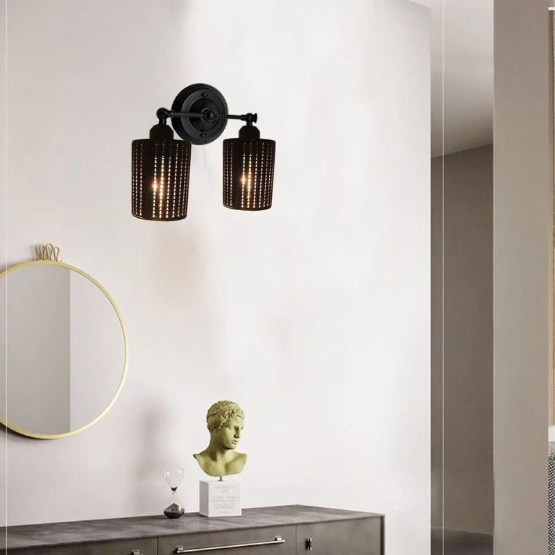 Brass wall lamp with brushed copper finish and iron housing, mounted on wall with decorative cage supports, no bulb installed.