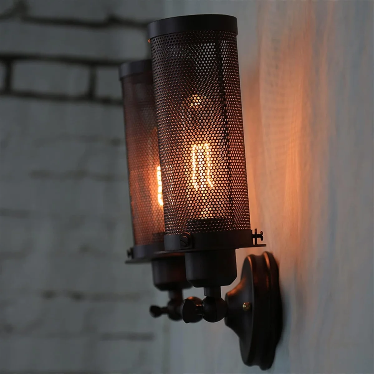 Metal double cage wall light with two interlocking cages, wall‑mounted, no bulbs shown, styled for modern interior spaces.