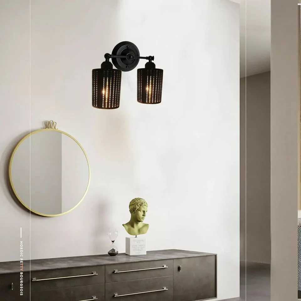 Pair of black industrial pendant shades with drum cage design, metal build, and open hollow structure for bright light spread