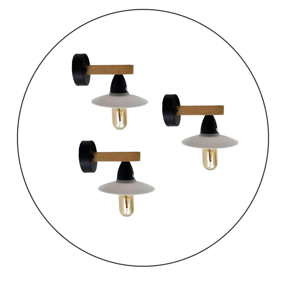 Three modern metal wall lighting fixtures with filament bulbs and PVC shades mounted on a white wall