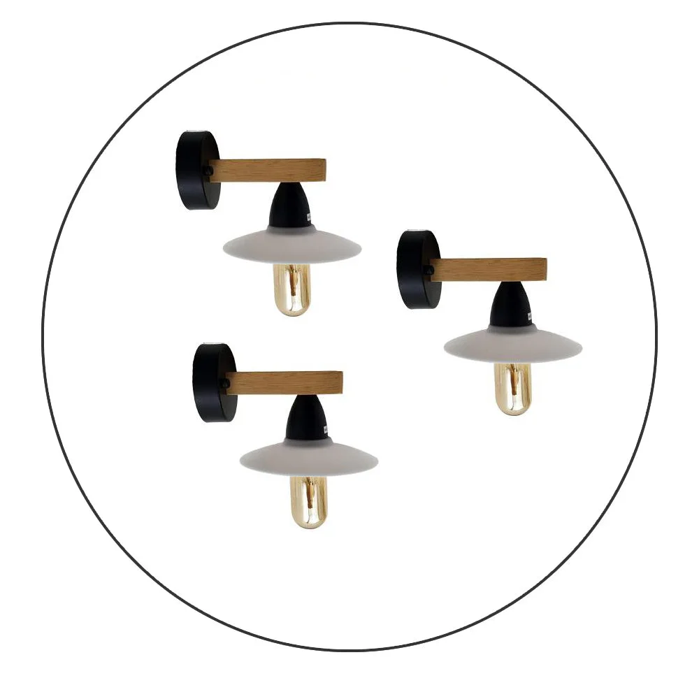 Three modern wall lights with filament bulbs, PVC shades, and natural wood mounted on a white wall in a hallway setting