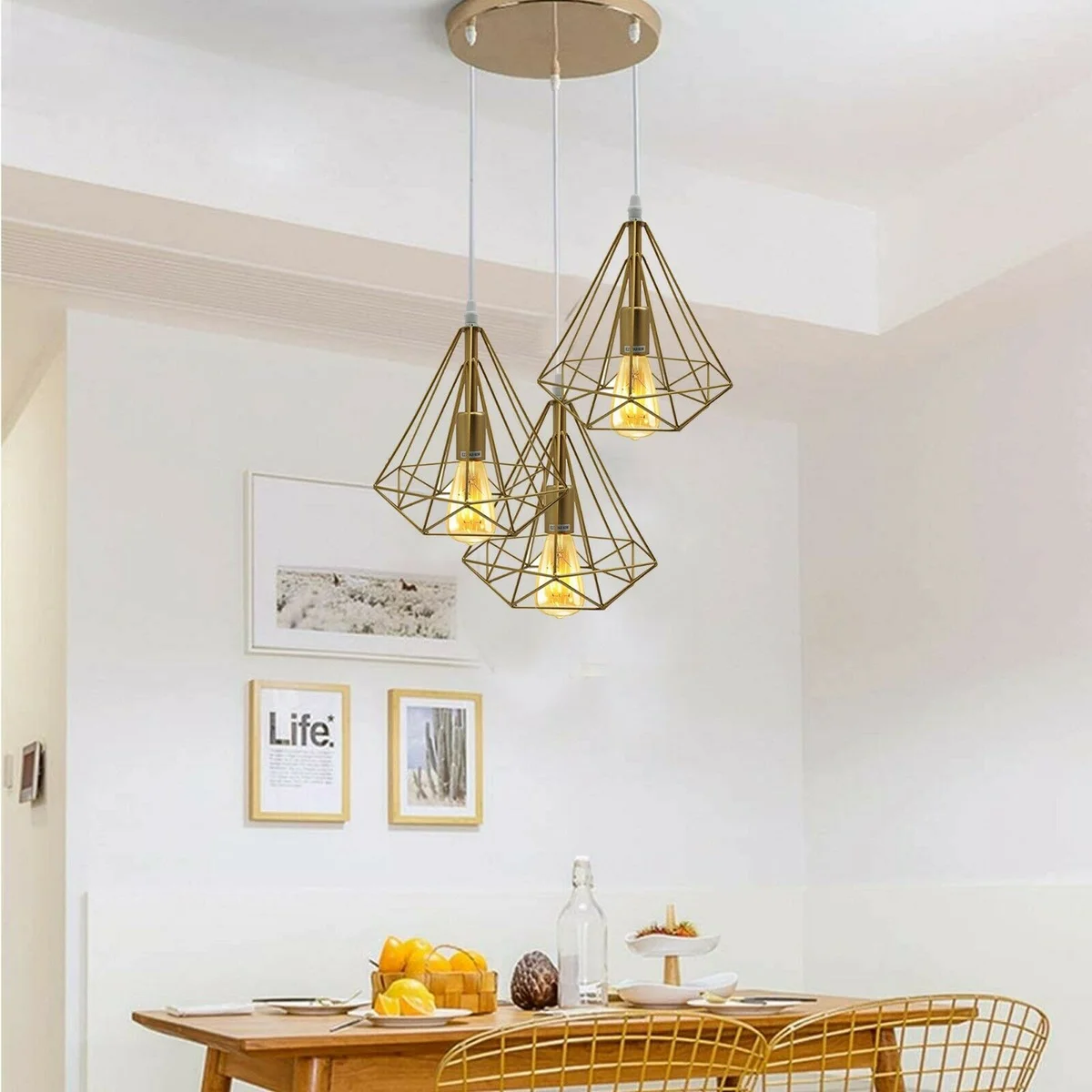 Modern vintage ceiling light with three gold metal and PVC lamp shades hanging from adjustable cables