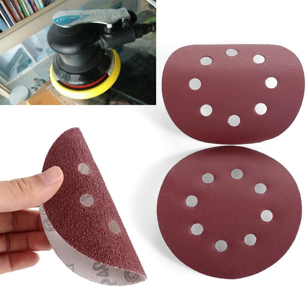 Five red sanding discs with 8 holes, 5 inch diameter, made of aluminum oxide for metal and wood polishing