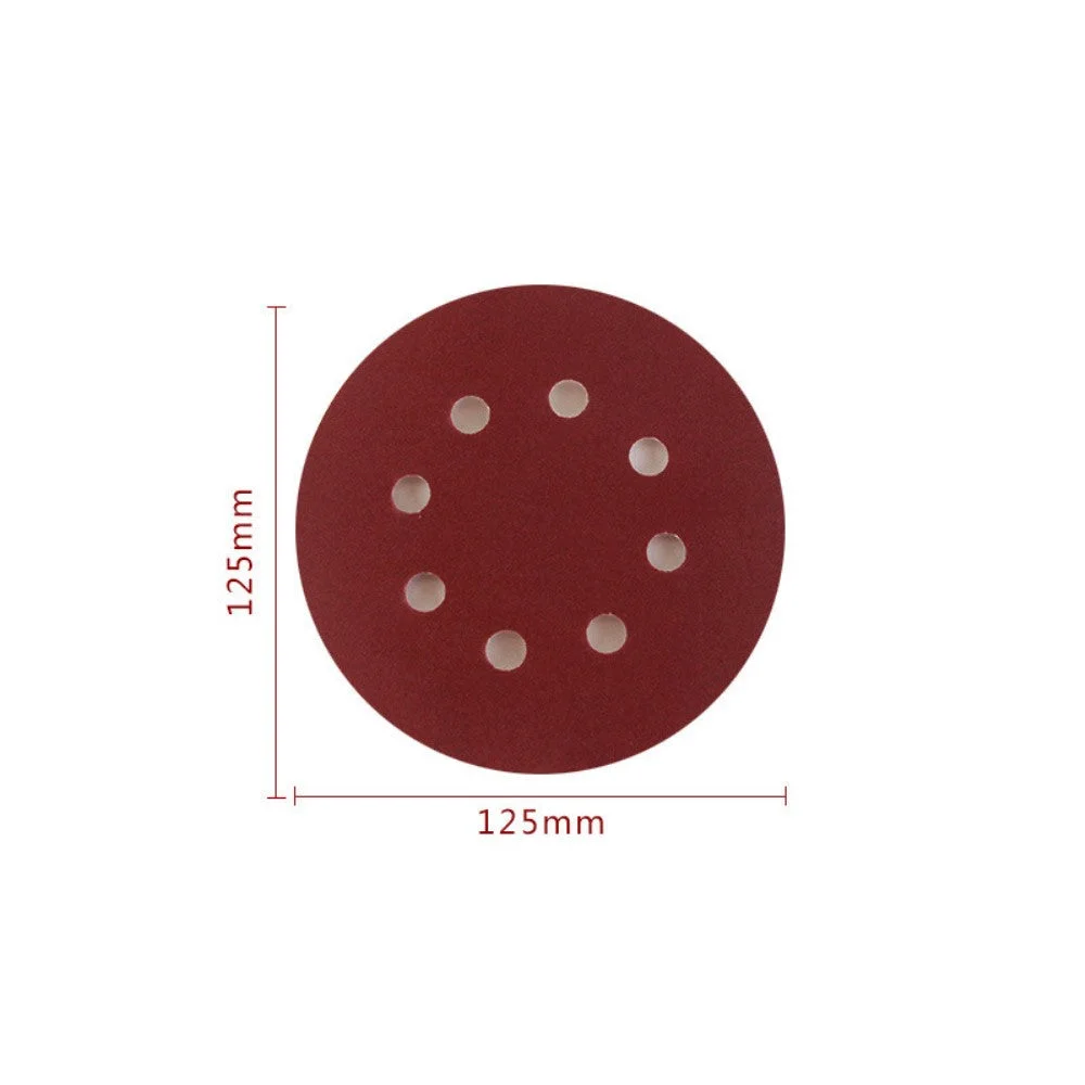 Set of reddish brown 5 inch 8 hole sanding discs with hook and loop backing stacked on a white background