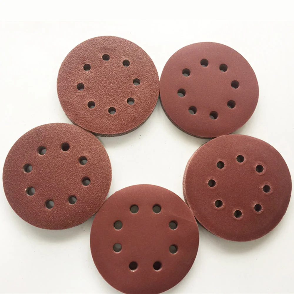 Stack of 125mm 5 inch 8 hole reddish brown 60 grit orbital sander discs for wood and metal sanding tasks