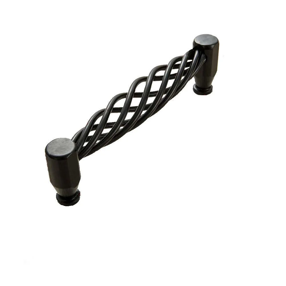 Matt black metal iron cupboard handles installed on wooden drawers with a vintage industrial style finish
