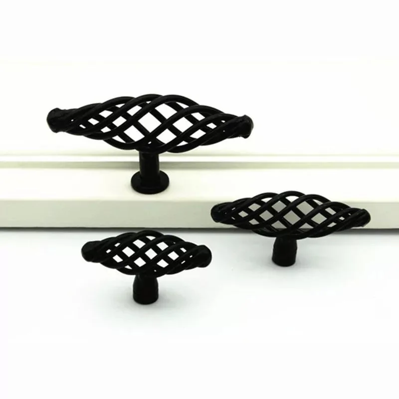 Vintage black cabinet handles with birdcage design, matte black iron, 100mm length, shown installed on wooden drawer front
