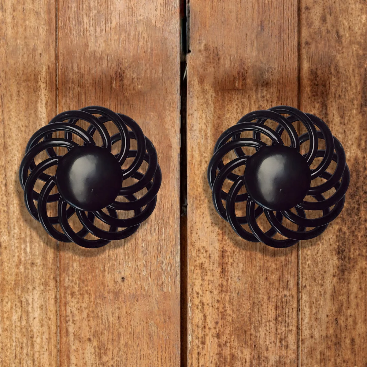 Black iron birdcage design vintage cupboard pull with matte black finish on wooden cabinet drawer front