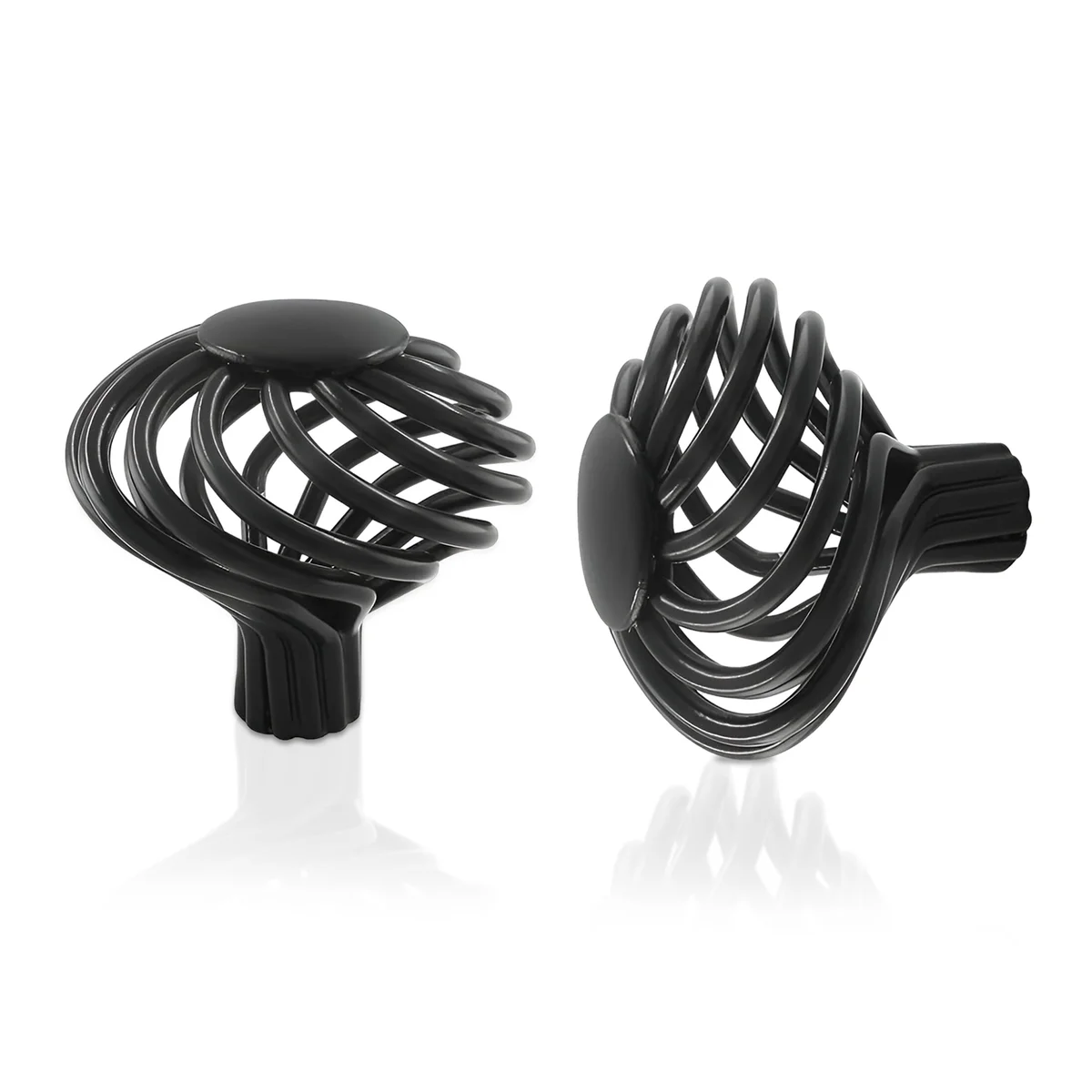 Black iron birdcage cupboard knob with matte black finish on a wooden drawer front, showing vintage decorative style