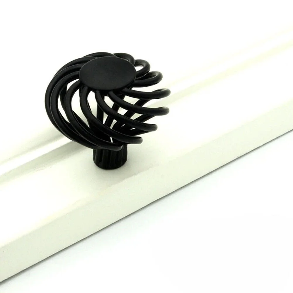 Black iron birdcage cupboard knob with matte black finish, 35mm diameter, styled on vintage wooden drawer front