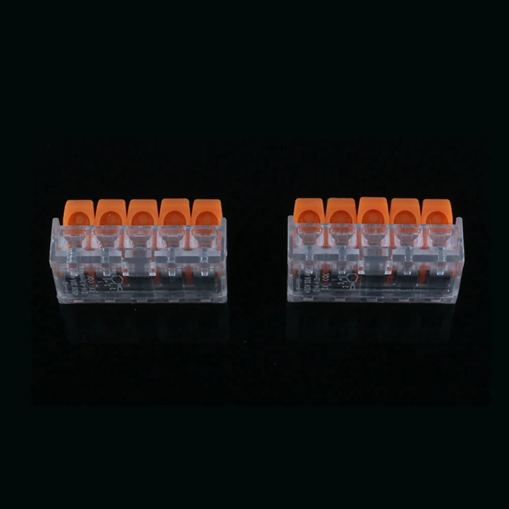 Five clear and orange 32A spring lever connectors arranged side by side showing lever mechanism and wire slots