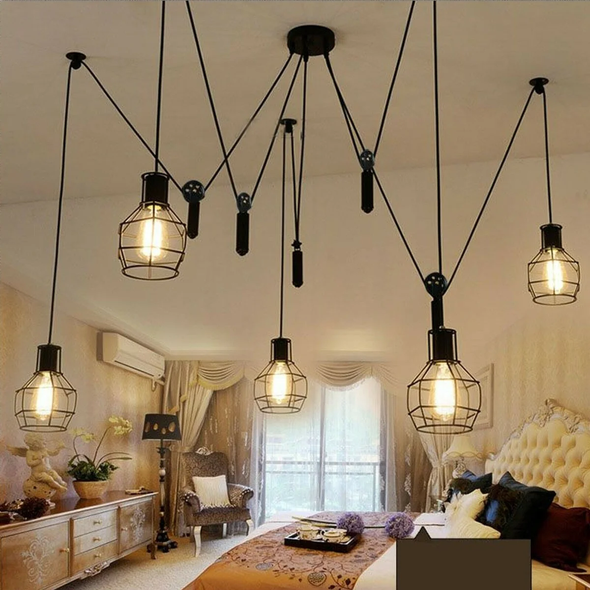 Five black metal cage pendant lights hanging from adjustable cords in an industrial ceiling light design with vintage style