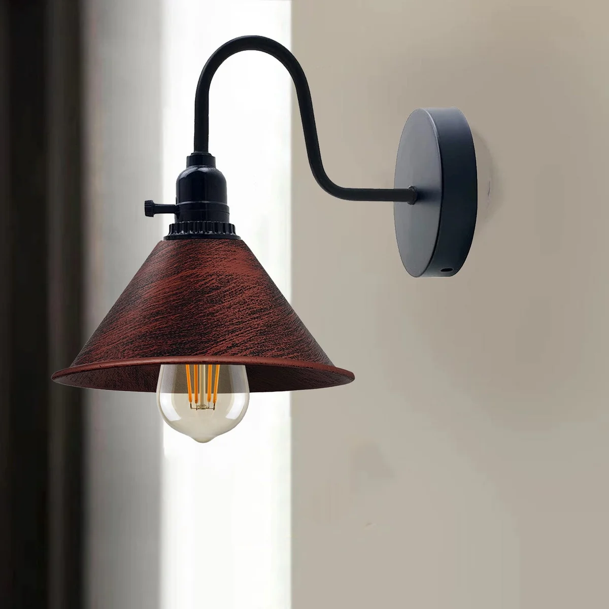 Rustic red wall sconce with cone-shaped metal shade and brushed copper base, featuring an on/off switch and round mounting plate