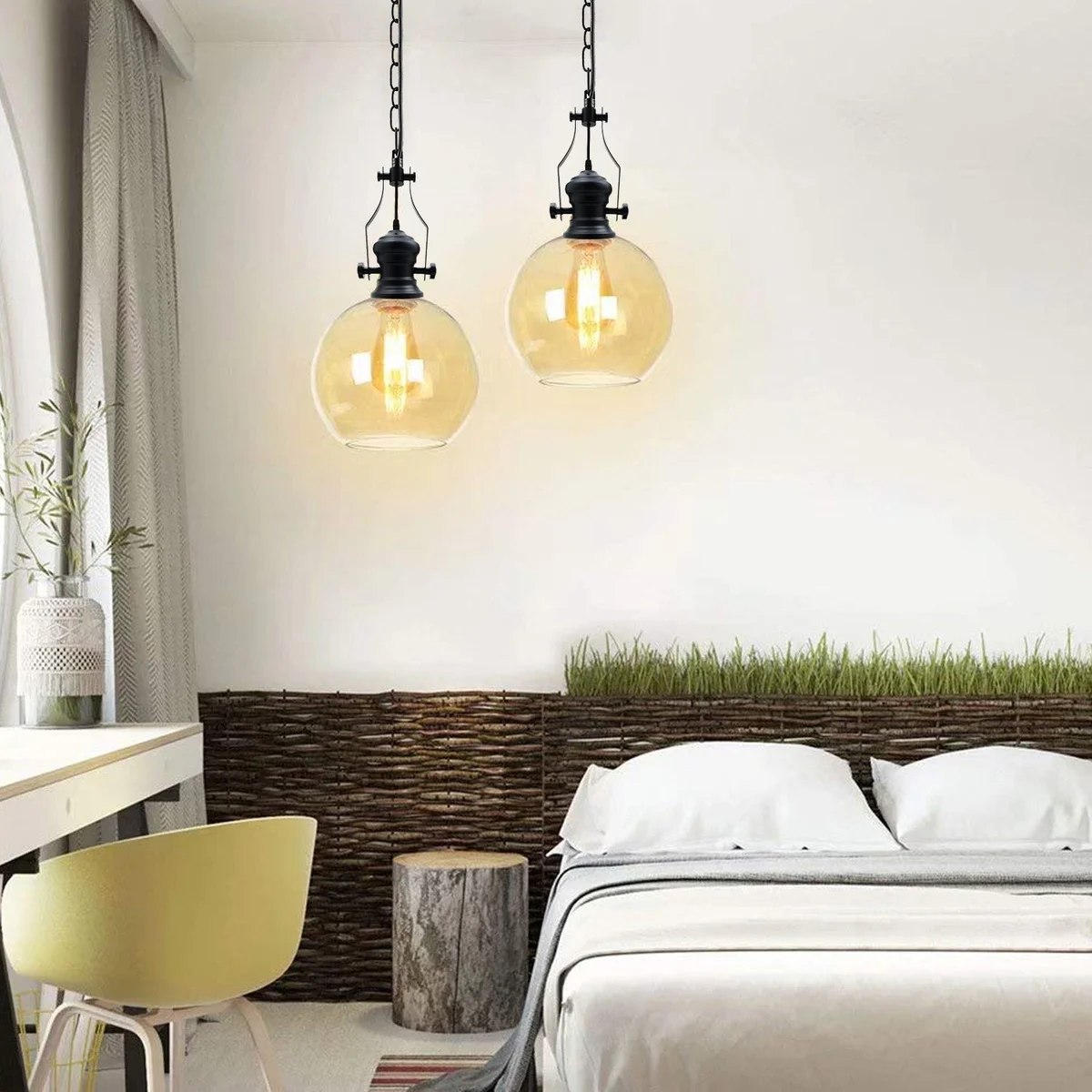 Amber glass E27 pendant light with black cable, round canopy, and industrial-style metal cage suspended from chain