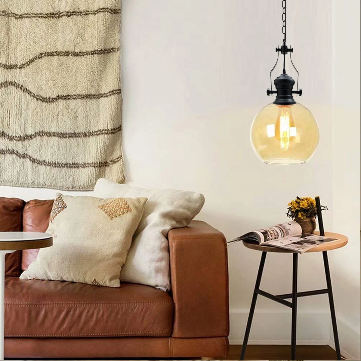 Amber glass industrial pendant light with black cage, round ceiling canopy, and 90cm chain hanging from ceiling