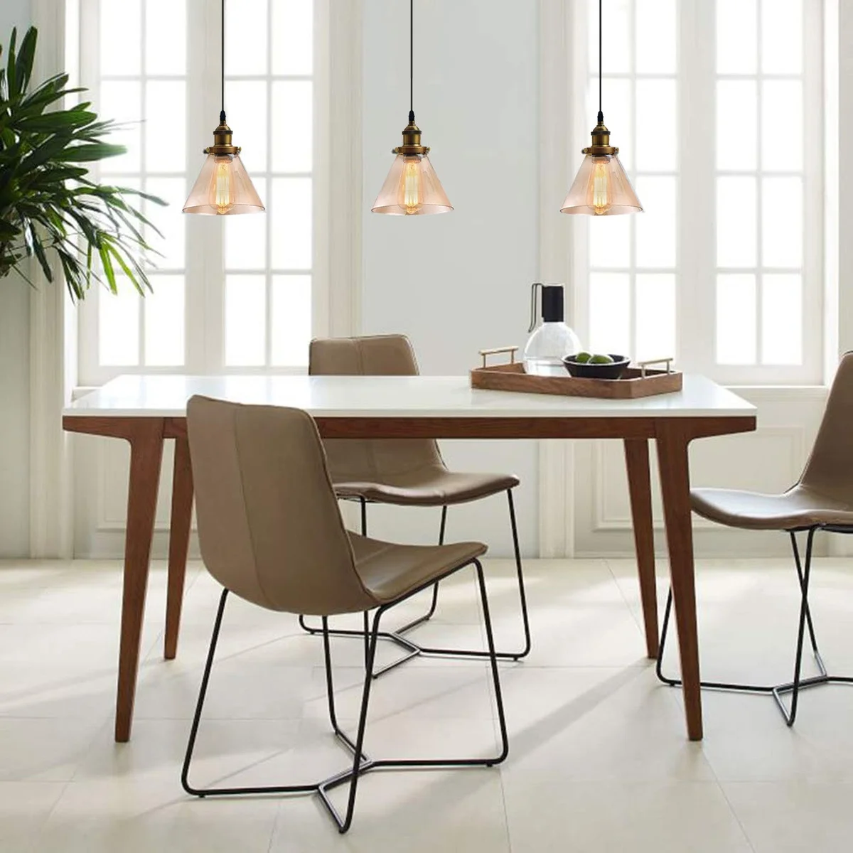 Three amber glass pendant lights with E27 screw and adjustable flex hanging from a black fixture, for modern pendant lighting.