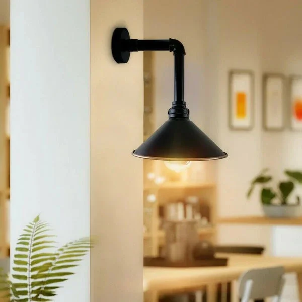 Indoor wall light – black metal pipe with cone shade, wall‑mounted, has an E27 bulb holder, fits living rooms.