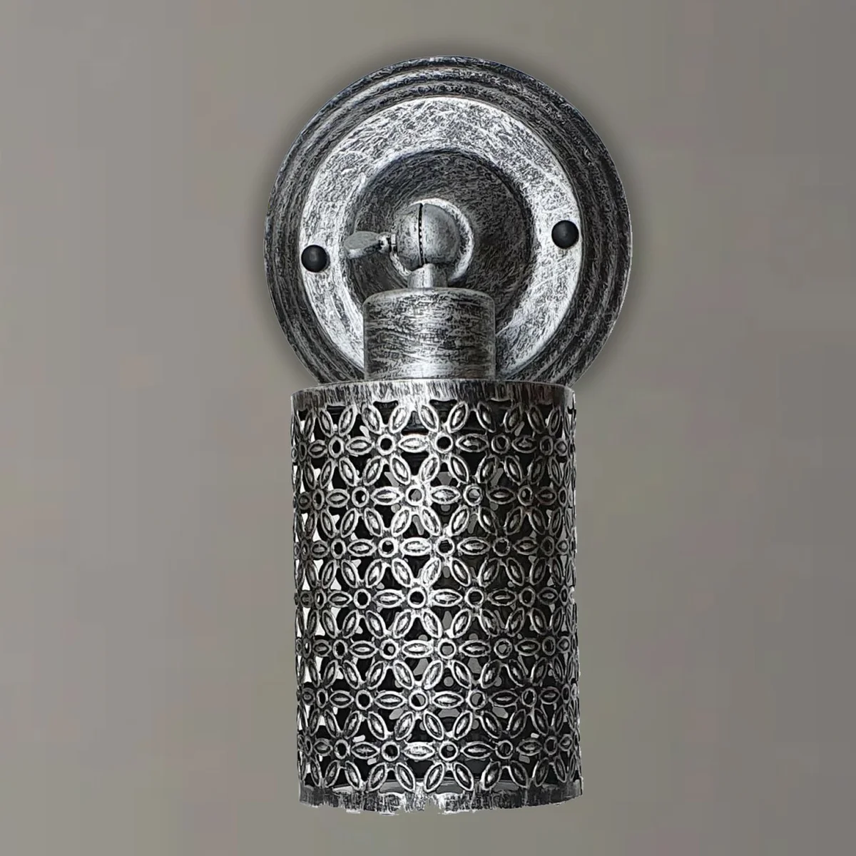 Rustic metal cage wall light with painted metal frame, E27 base and warm bulb visible.