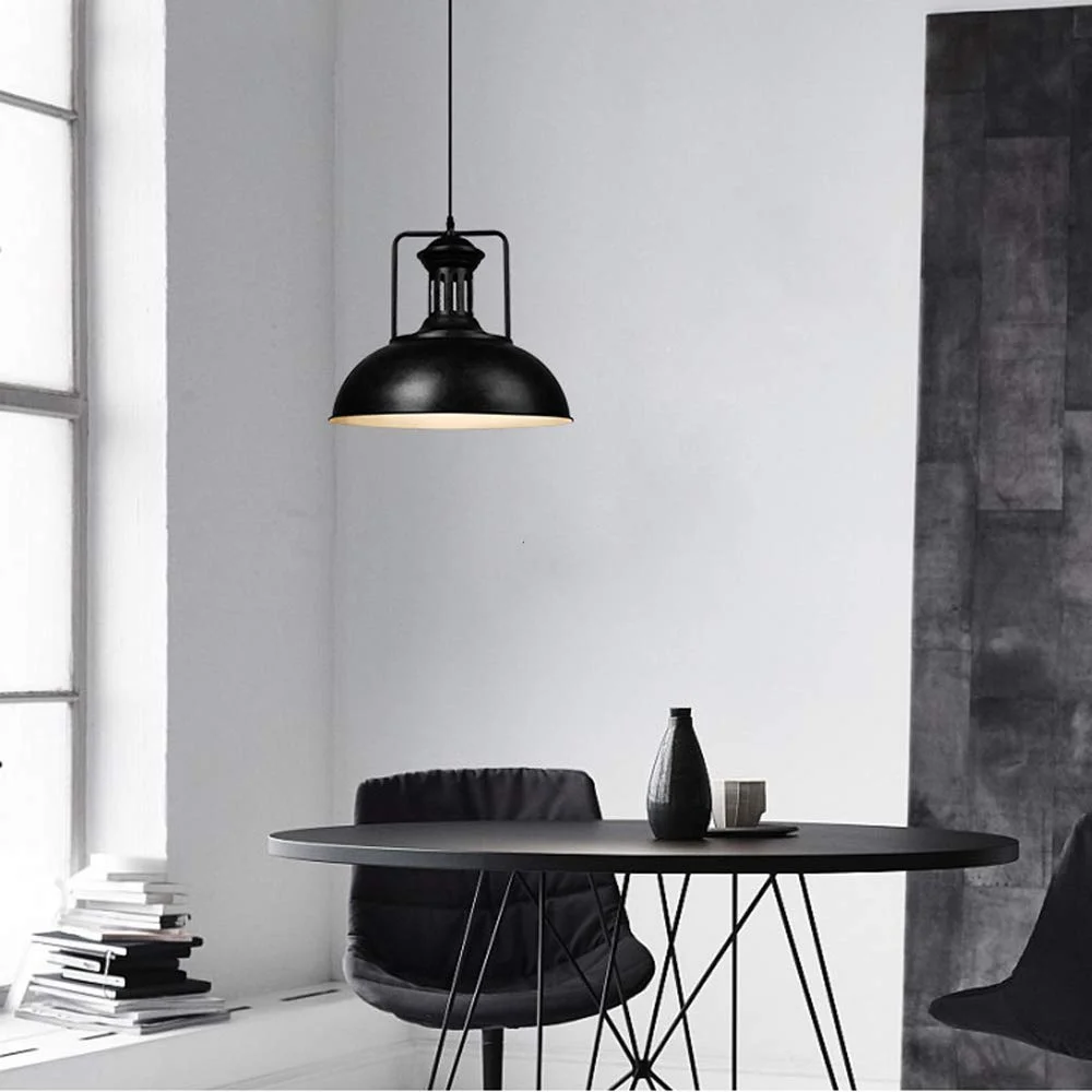 Industrial metal pendant light with antique hand‑painted black metal shade and adjustable chain hanging from ceiling.