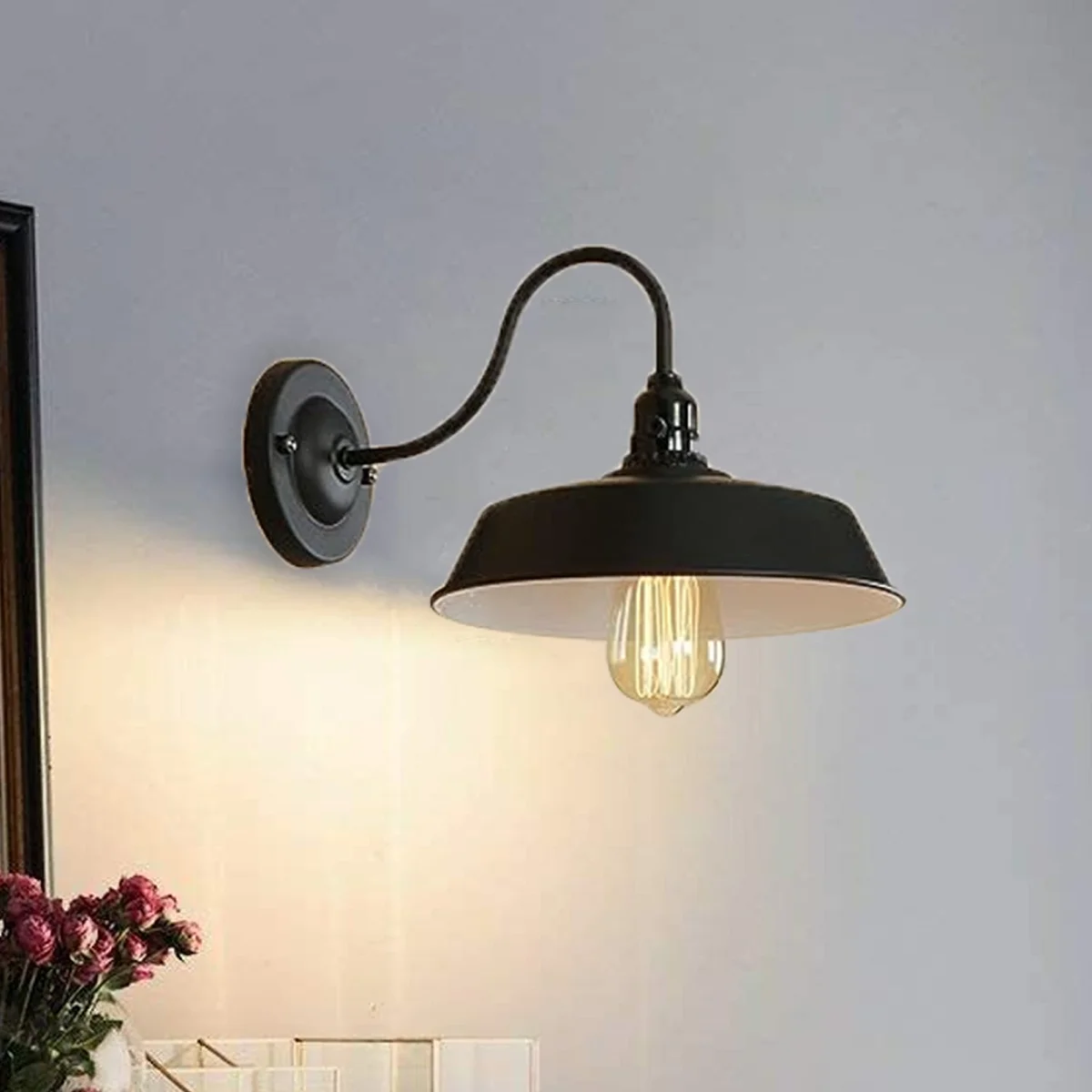 Vintage industrial wall light with curved swan neck, matte black iron holder, E27 base, framed by a ceiling rose.
