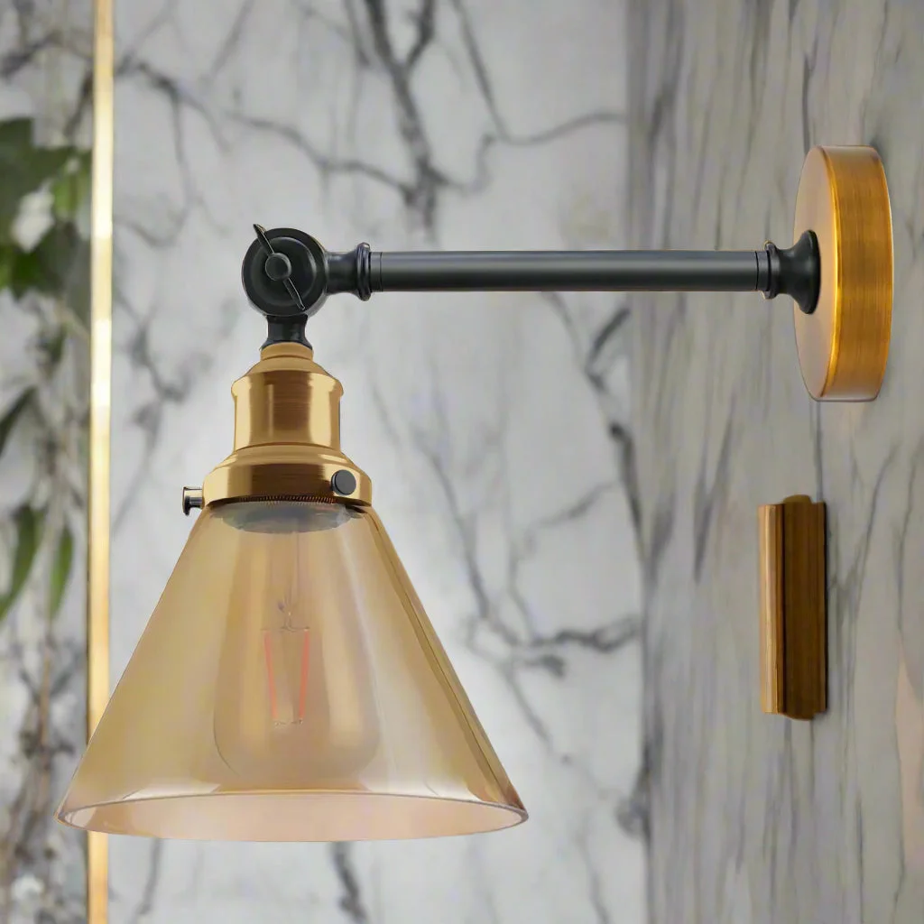 Adjustable wall lamp with amber glass shade and copper-plated base, vintage industrial style, emitting warm light.