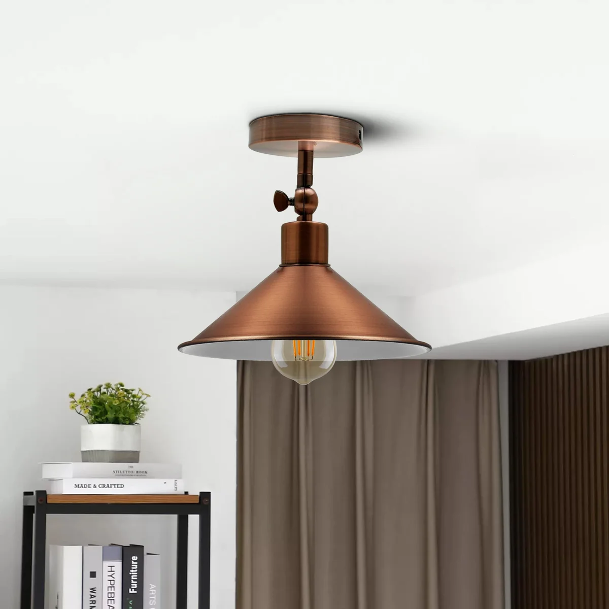Copper pendant light with industrial metal shade hanging from a 10cm ceiling rose, featuring a warm, romantic atmosphere.