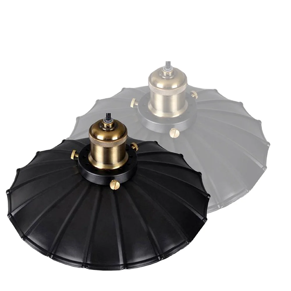 Retro black wavy metal lampshade hanging from thin fabric cable on modern ceiling.