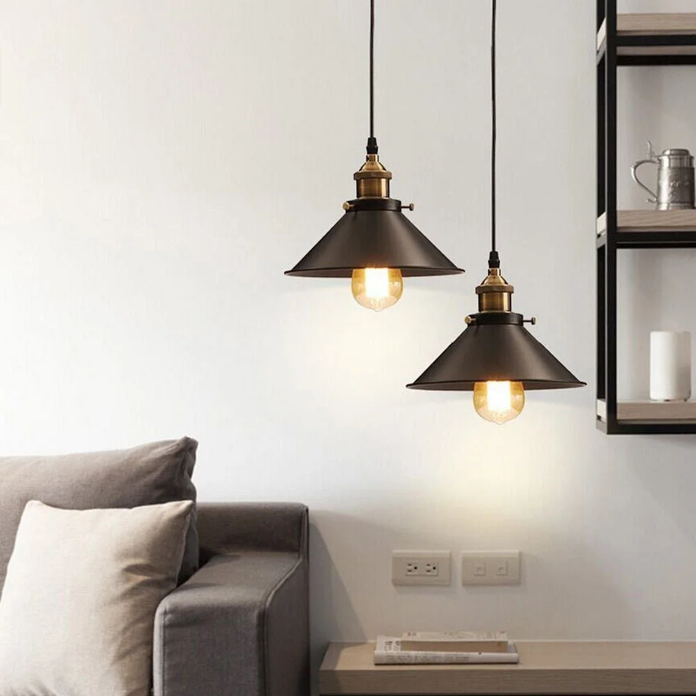 E27 pendant light fitting with flat black round shade, black fabric cable, round black canopy, brown wire visible.