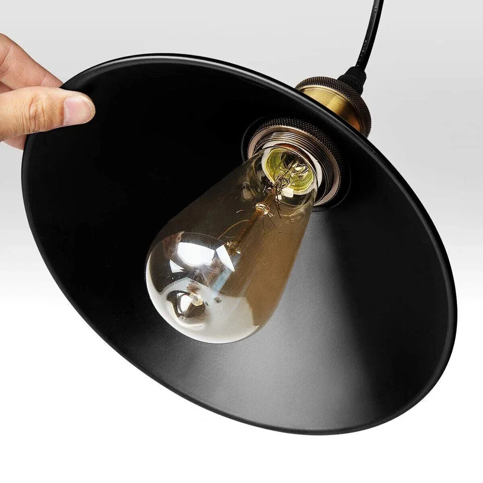 Black pendant light with gold E27 lamp holder and round black fabric shade hanging on a ceiling rose