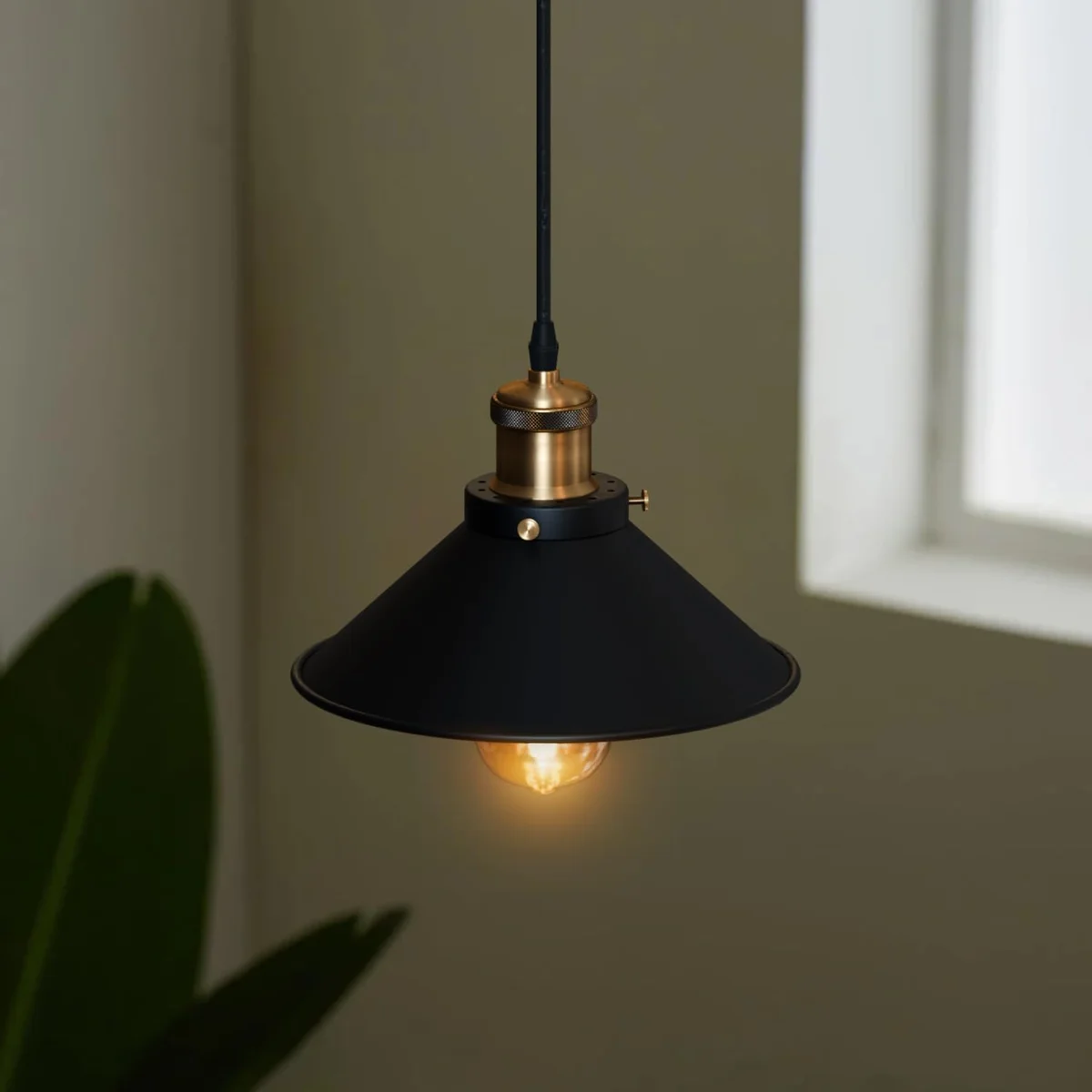 Modern black pendant light with gold lamp holder, round 21cm shade, black fabric cable, E27 socket.