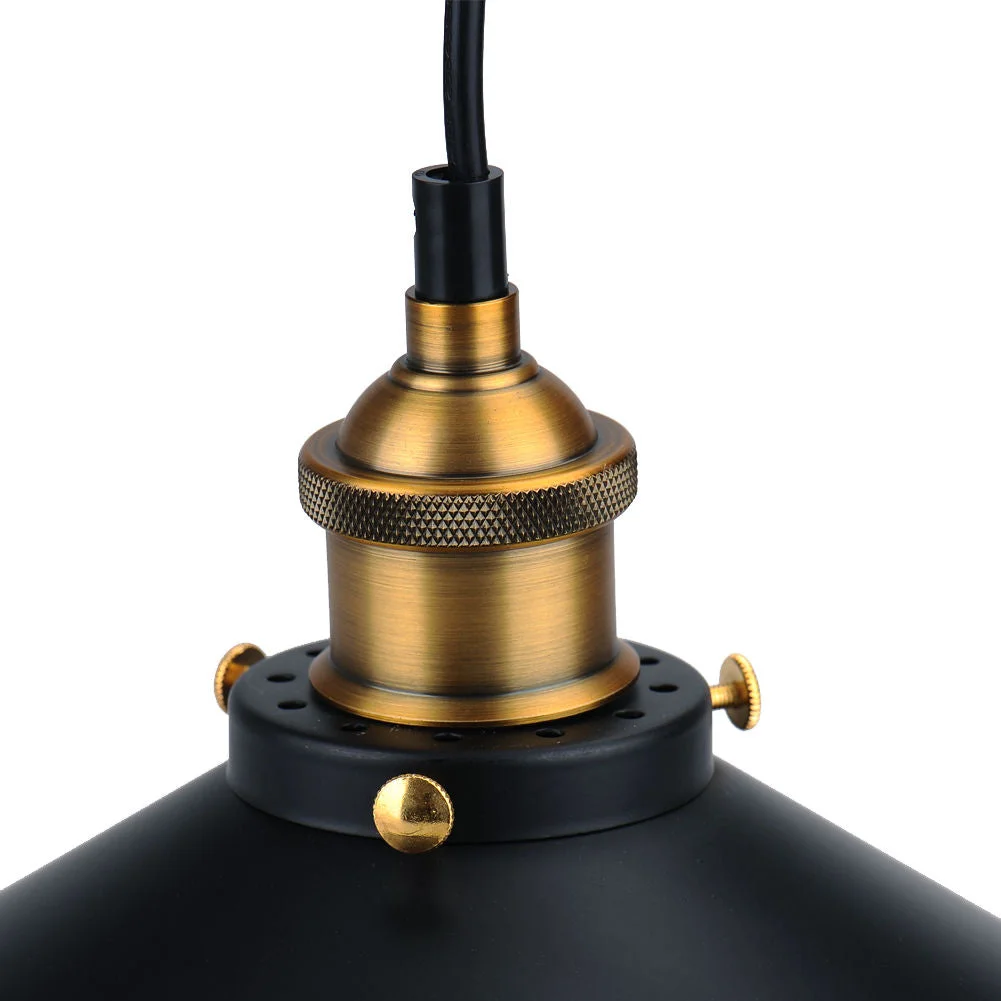 Black pendant light with matte black shade and gold lamp holder and black fabric cable.