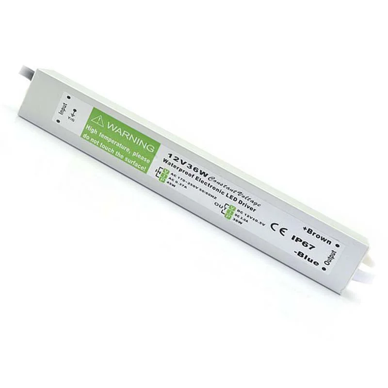 Slim aluminium LED driver with polished aluminium casing, black rubber‑sealed cable and 12 V DC output label.