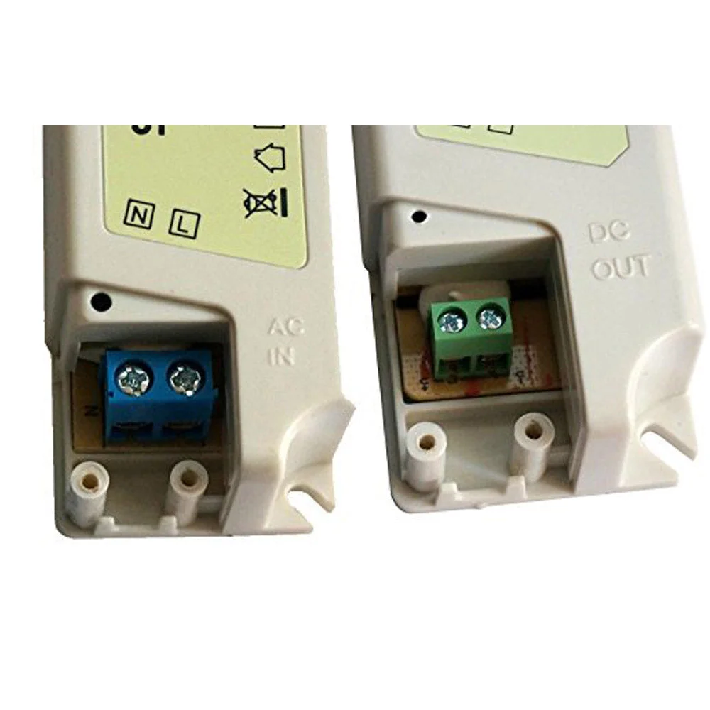 Compact plastic DC 12V power supply with screw terminals, clearly labelled 12V/2.9A, mounted on a wall with adhesive strip.