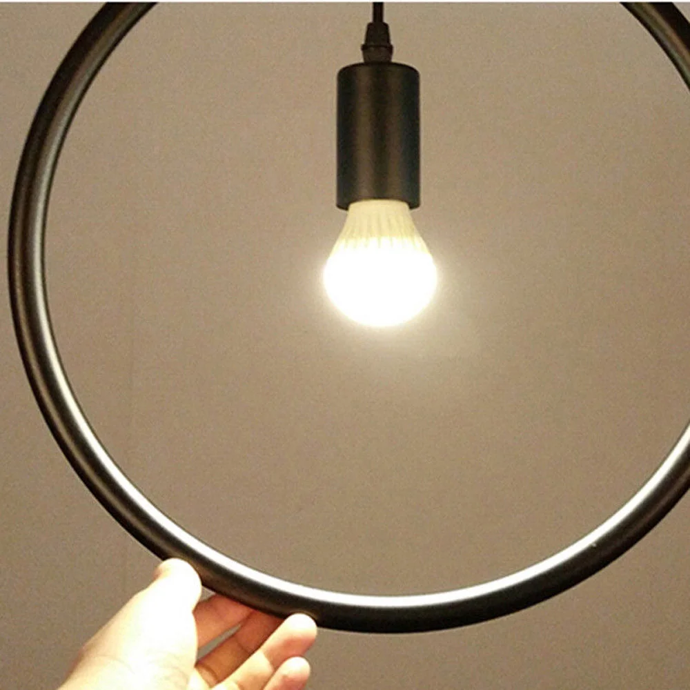 Black metal pendant light in a circle shape, 36 cm diameter, hanging from ceiling with adjustable cable.