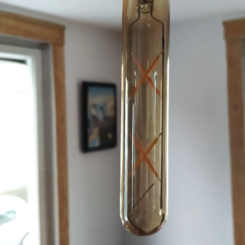 Amber T185 LED vintage bulb with curved glass coating, 4W screw base, marked 2700K, an energy efficient bulb.