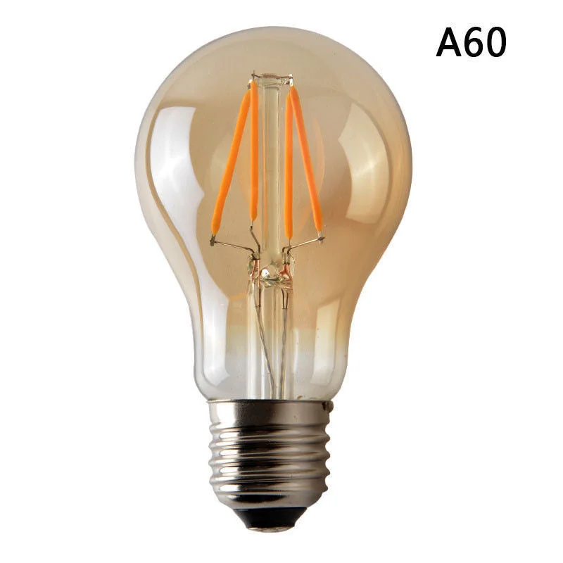 A60 LED bulb with amber glass, vintage Edison style, 4W, B22 base, softly glowing.