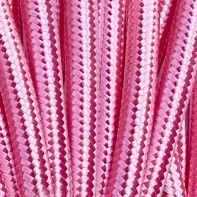 Shiny pink vintage braided fabric cable coil with visible round PVC sheath and copper cores.