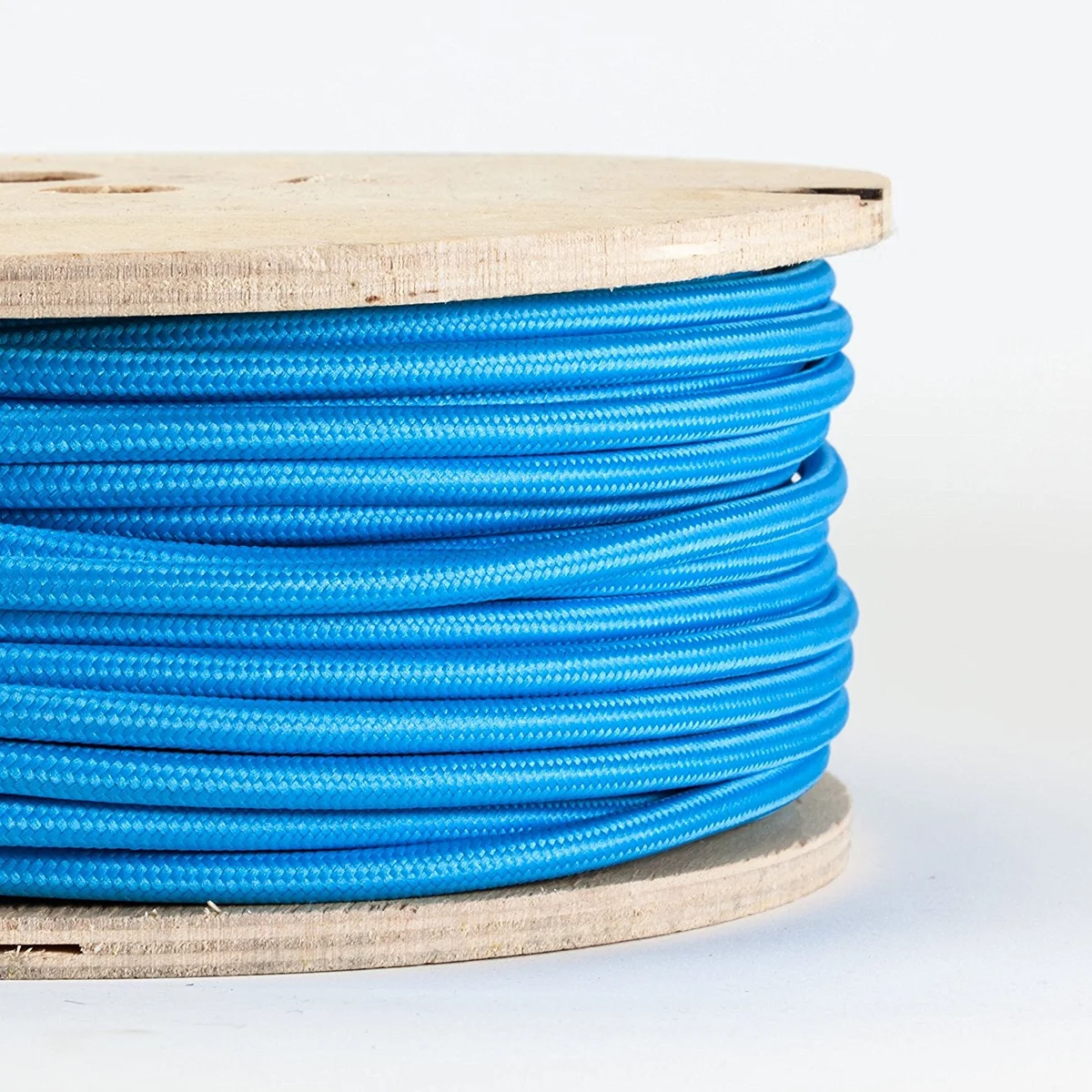 Blue vintage round fabric cable with 3 core strands, shown coiled on a reel, suitable for lighting projects.