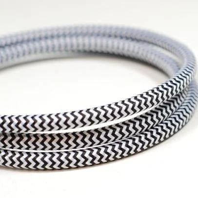 Black and white braided round 3‑core indoor lighting cable, 7 mm diameter, shown coiled at 1m length.